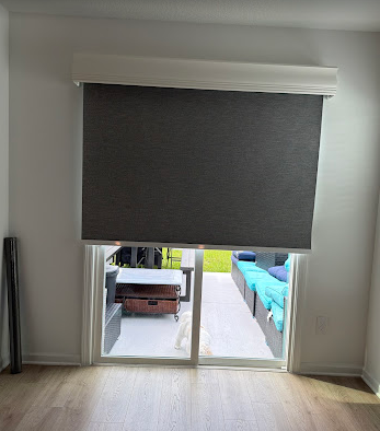 Custom blackout roller shade installed over a sliding glass door in a Ponte Vedra home