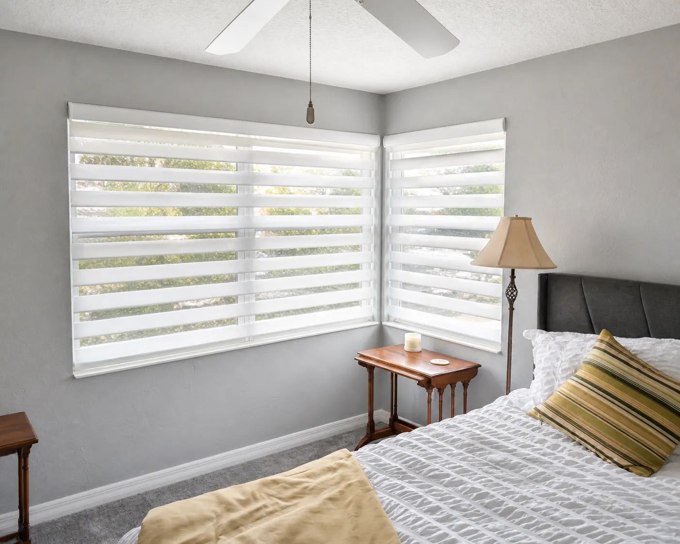 Custom white zebra shades providing filtered light and privacy in a Ponte Vedra bedroom