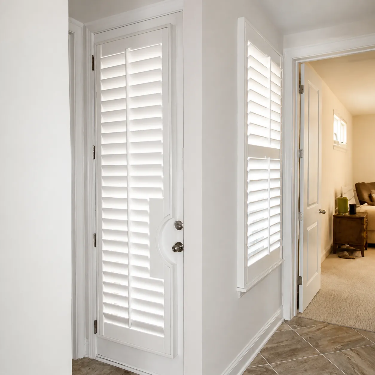 Custom door and sidelight shutters in Ponte Vedra Custom white door and sidelight shutters fitted for privacy in a Ponte Vedra home