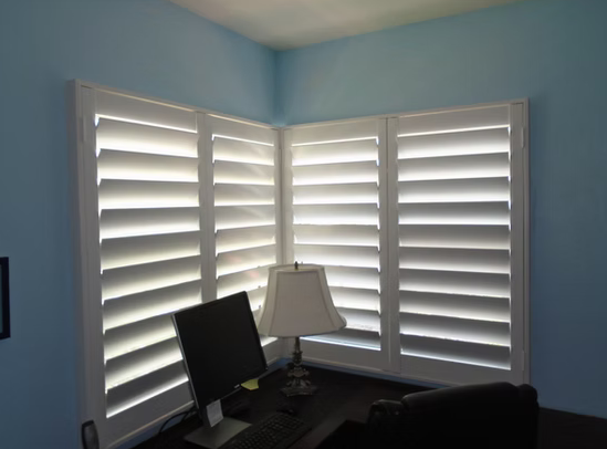 Corner window plantation shutters in a Ponte Vedra home office