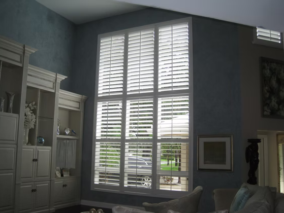 Two-story plantation shutter installation in a Ponte Vedra living room