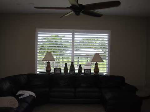 Wide living room plantation shutter installation for a Ponte Vedra homeowner