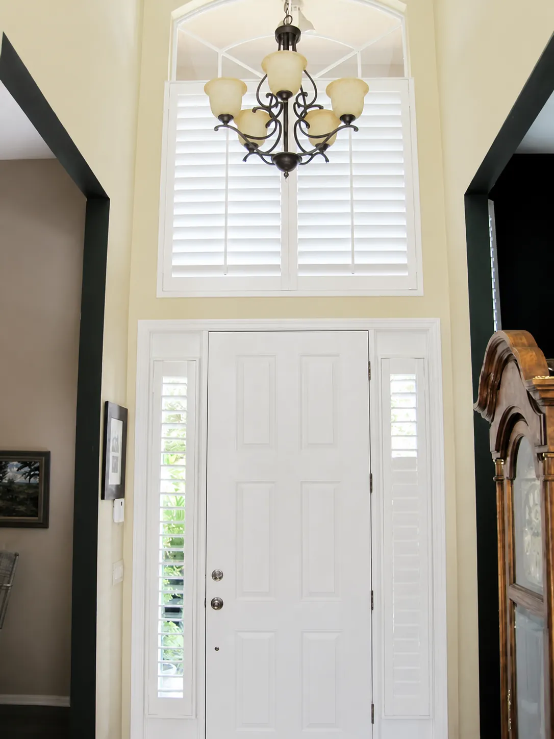 Plantation shutters above a front entry